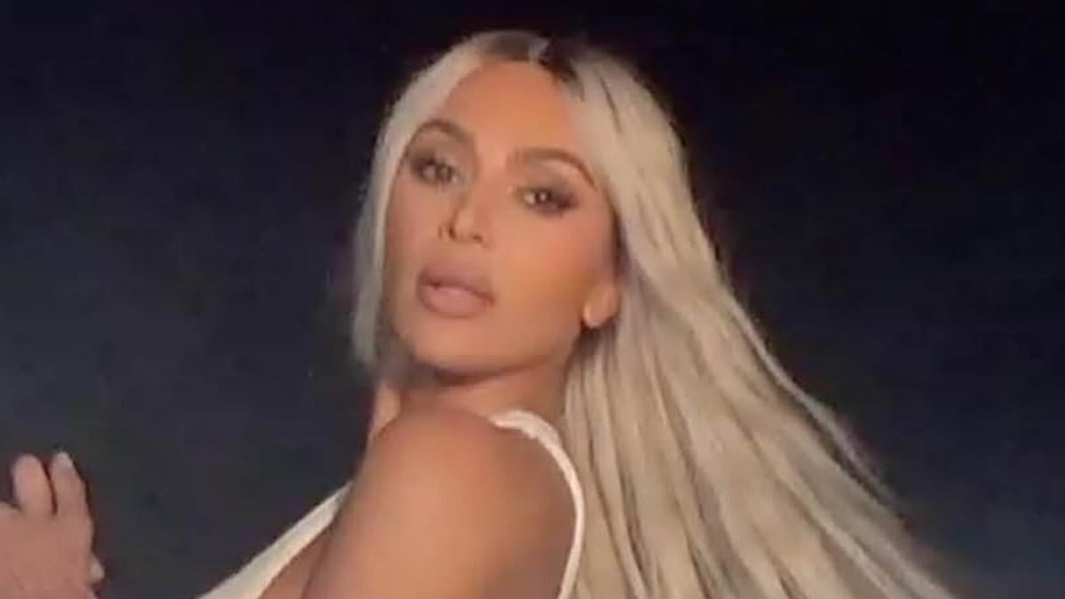 Kim Kardashian loves her new set of wheels as she rocks leather pants and a crop top for a steamy photoshoot with her Tesla Cybertruck