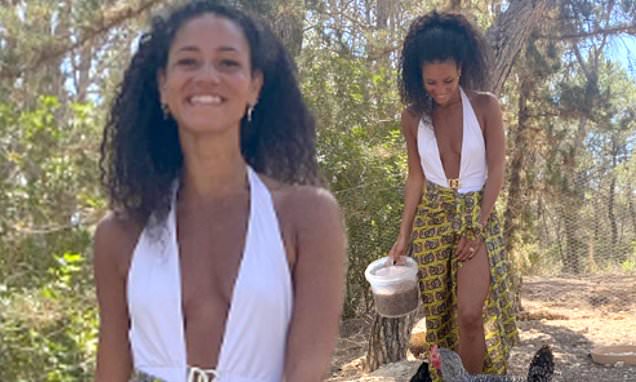 Vick Hope wows in a plunging white swimsuit