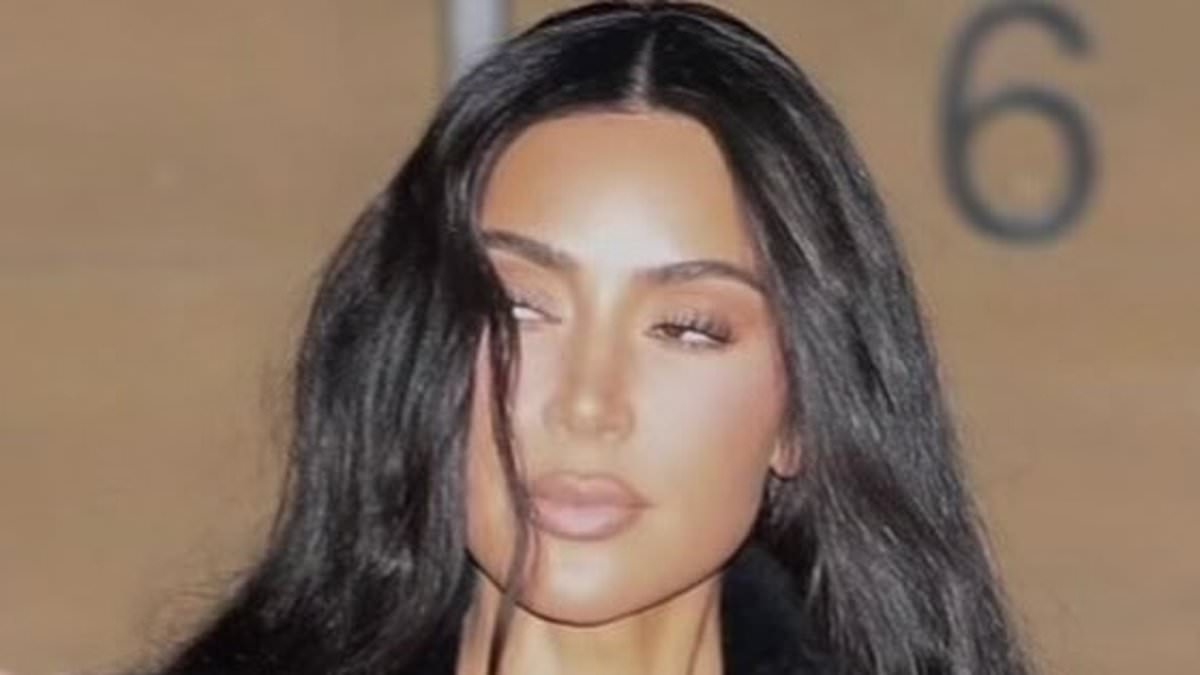 Kim Kardashian shows off her sculpted figure in a skimpy bandeau top and fuzzy black pants... as star continues to brush off Taylor Swift diss in singer's new album