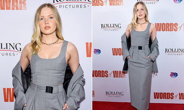 Ellie Bamber cuts a typically chic figure in a light grey skirt co-ord
