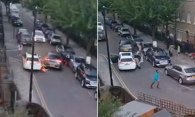Moment pedestrian is run over by reversing car before being hit AGAIN