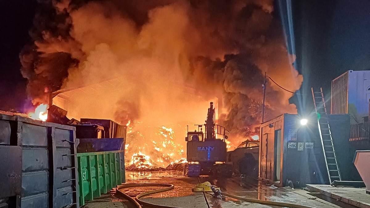 Crews tackle huge late-night blaze at industrial estate with warehouse, cranes and vehicles on fire