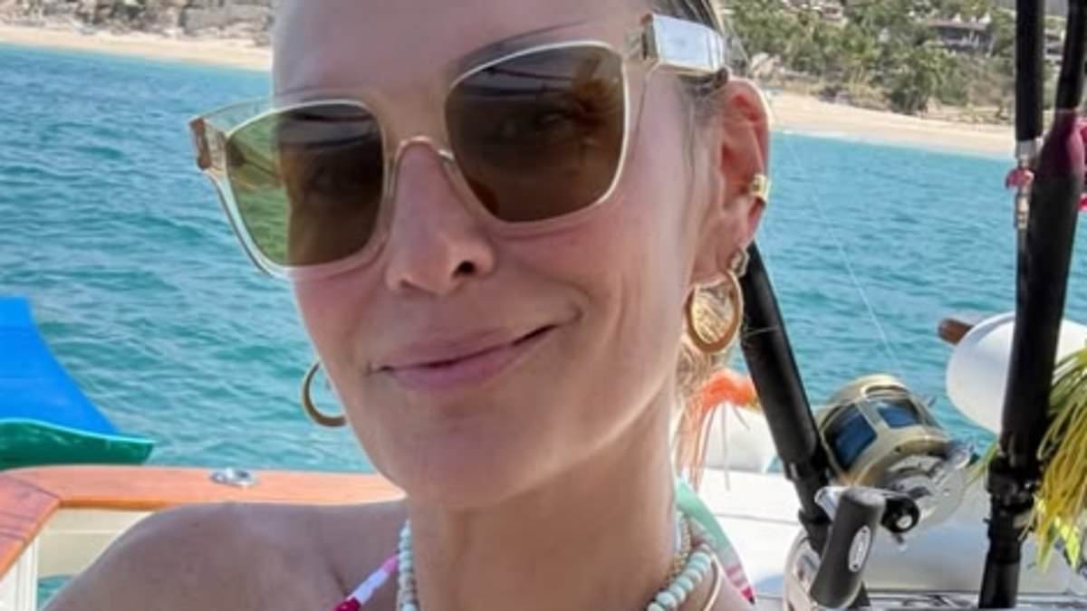 Molly Sims, 52, looks slender in a bikini while jumping off her yacht... after sizzling in Sports Illustrated shoot